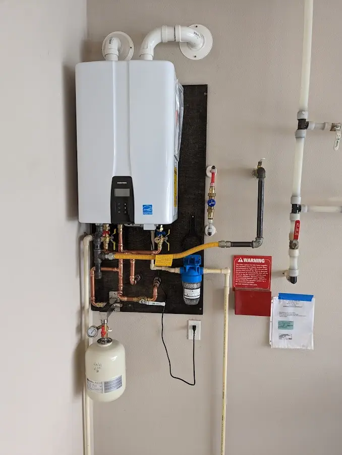 Professional plumber installing copper piping in a Roxborough Park home